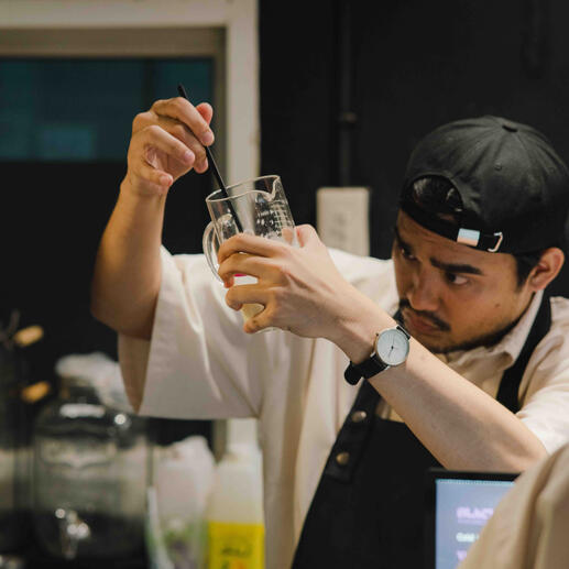 Hands behind the cold brew.